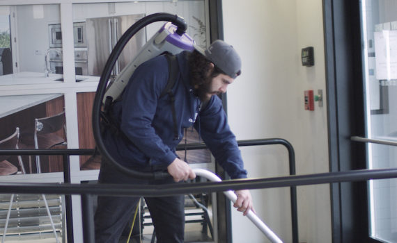 Cleansolution employee using a backpack vacuum.