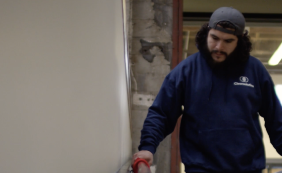 Cleansolution employee wearing a navy blue sweatshirt.