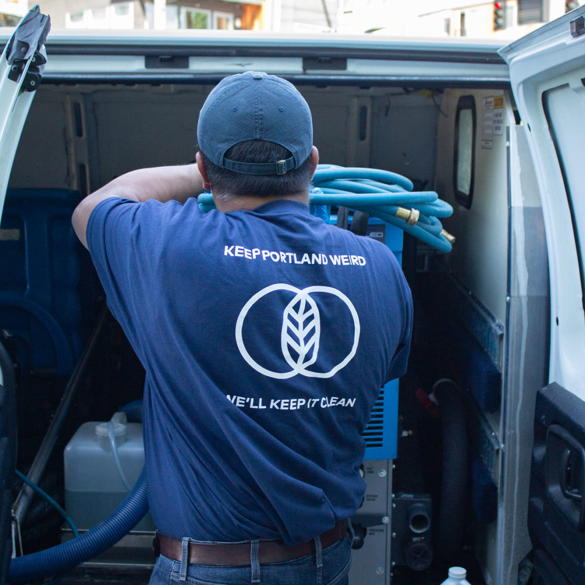 Cleaner unloading equipment from a van.