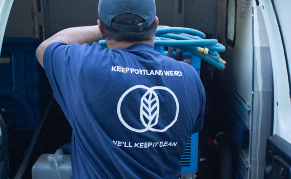 Cleaner unloading equipment from a van.